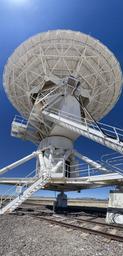 Standing at the base of the dish.